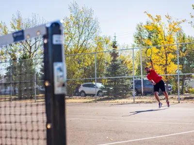 Photo of a man serving a tennis ball