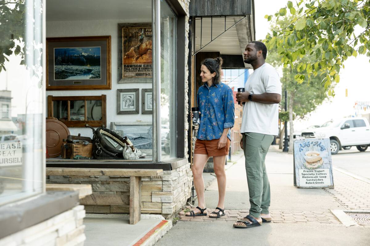 A photo of a man and a woman looking at a store window