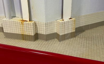 Photo of rust on a tiled wall
