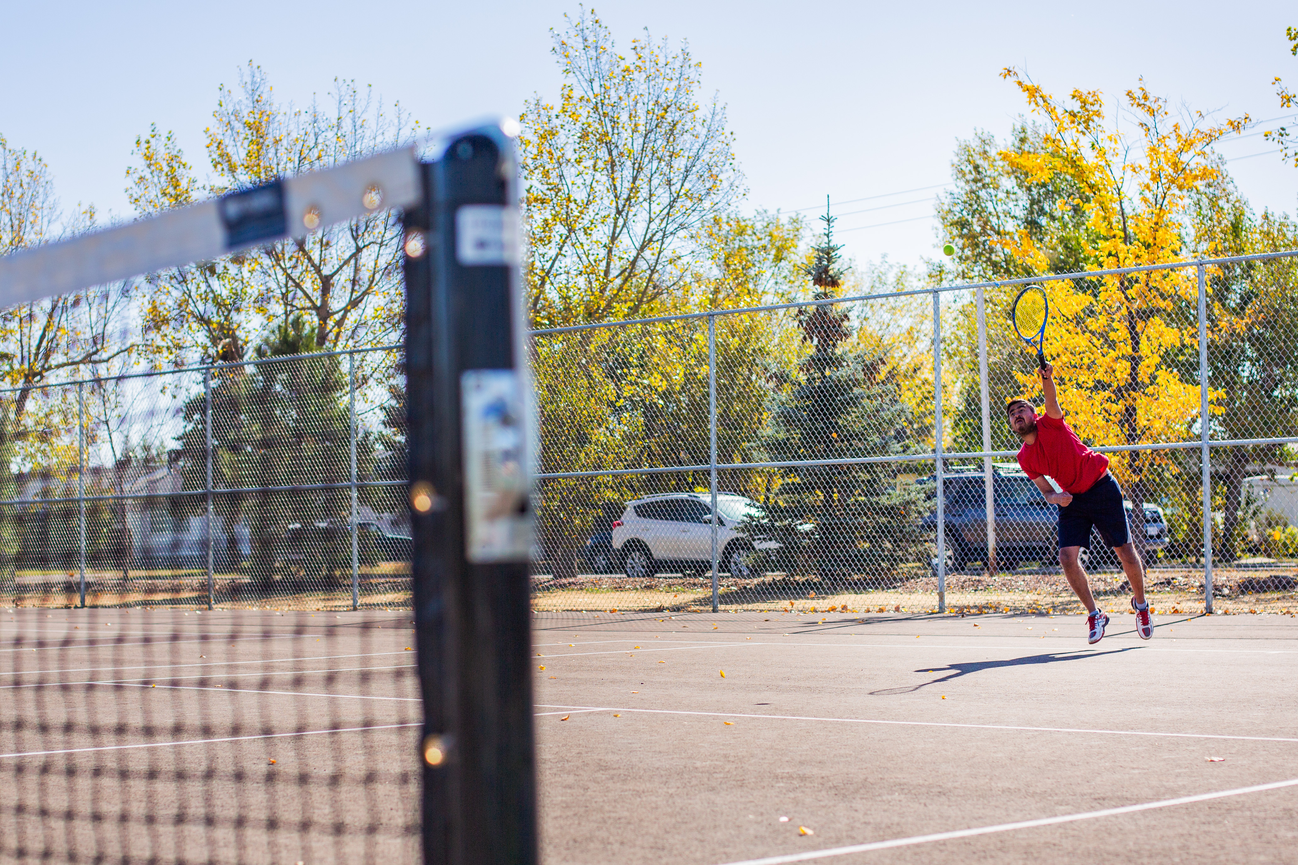 Photo of a man serving a tennis ball